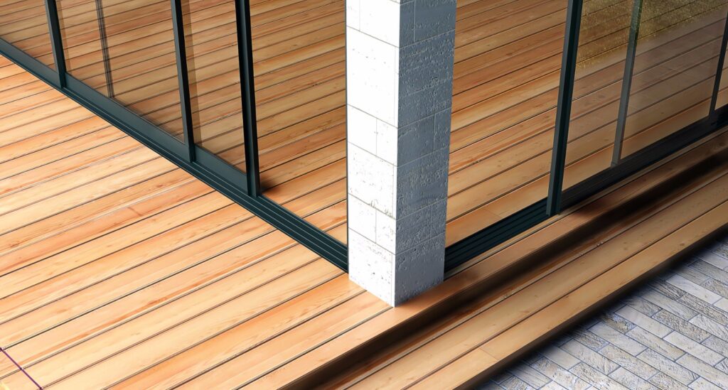 Sürme Sineklik | Bursa'da Dayanıklı ve Kullanışlı Raylı Çözüm 3 Ahşap zeminli bir terasta kurulu, zemine gömülü ray sistemine sahip modern eşiksiz sürgülü cam kapı sistemi.